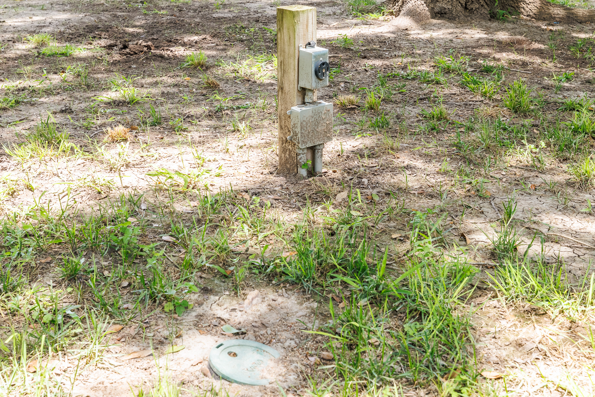 Tbd Goodwin Road Gonzales, TX 78629 - Photo 17 of 33 A well-maintained electrical hookup post stands ready amidst a verdant landscape.