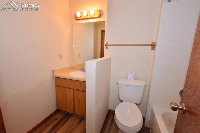 a white toilet sitting next to a bathroom sink