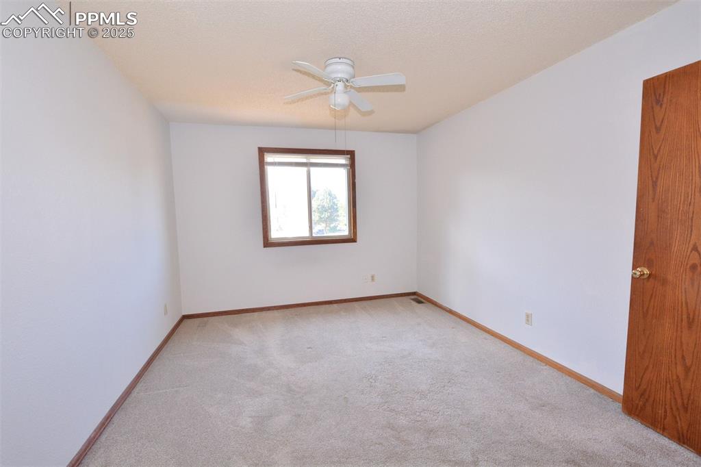 1021 Dublin Boulevard Colorado Springs, CO 80918 - Photo 14 of 20 an empty room with a ceiling fan and a window