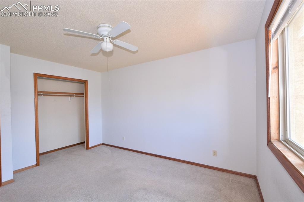 1021 Dublin Boulevard Colorado Springs, CO 80918 - Photo 15 of 20 an empty room with windows and fan