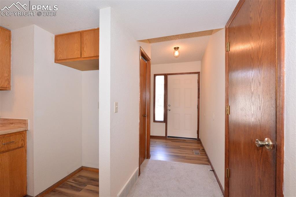 1021 Dublin Boulevard Colorado Springs, CO 80918 - Photo 3 of 20 a view of a hallway with wooden floor