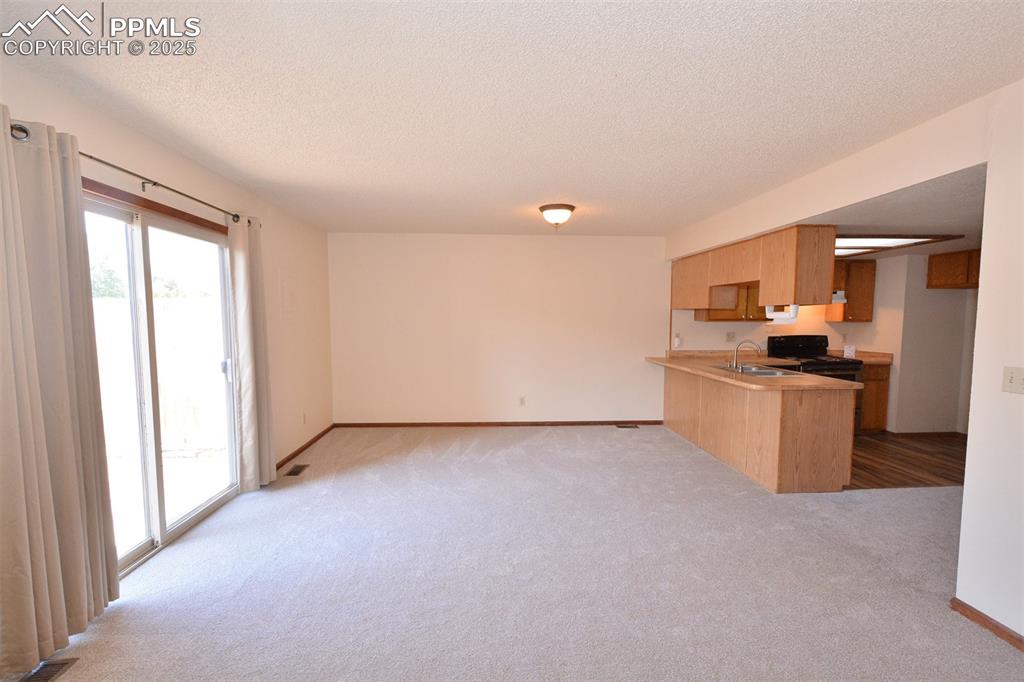 1021 Dublin Boulevard Colorado Springs, CO 80918 - Photo 8 of 20 a view of a kitchen with a sink stove and cabinet