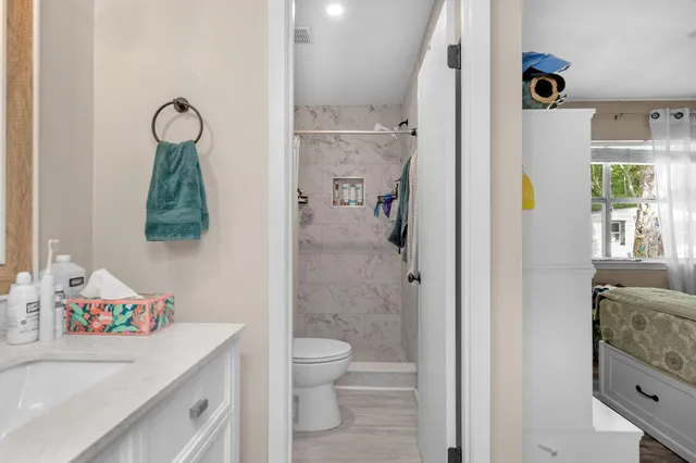 a bathroom with a sink a toilet and a mirror