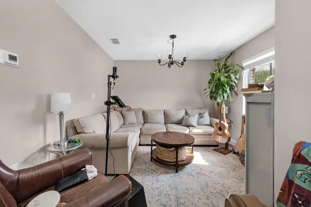 a living room with furniture and a potted plant
