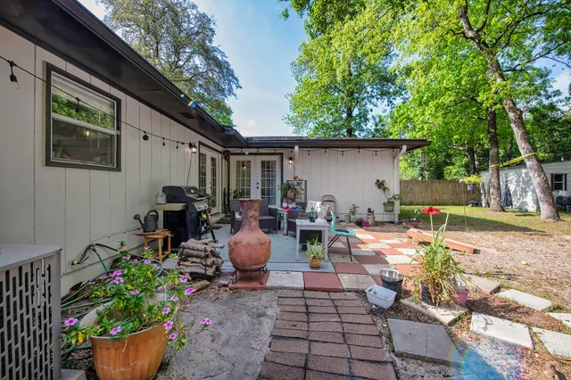 a view of a backyard with sitting area and garden