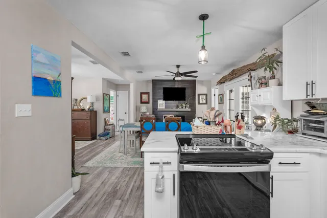 a kitchen view with microwave a stove and refrigerator