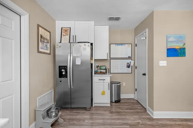 a kitchen with stainless steel appliances a refrigerator and a stove top oven