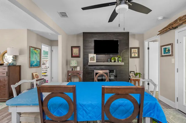 a living room with furniture a flat screen tv and kitchen view