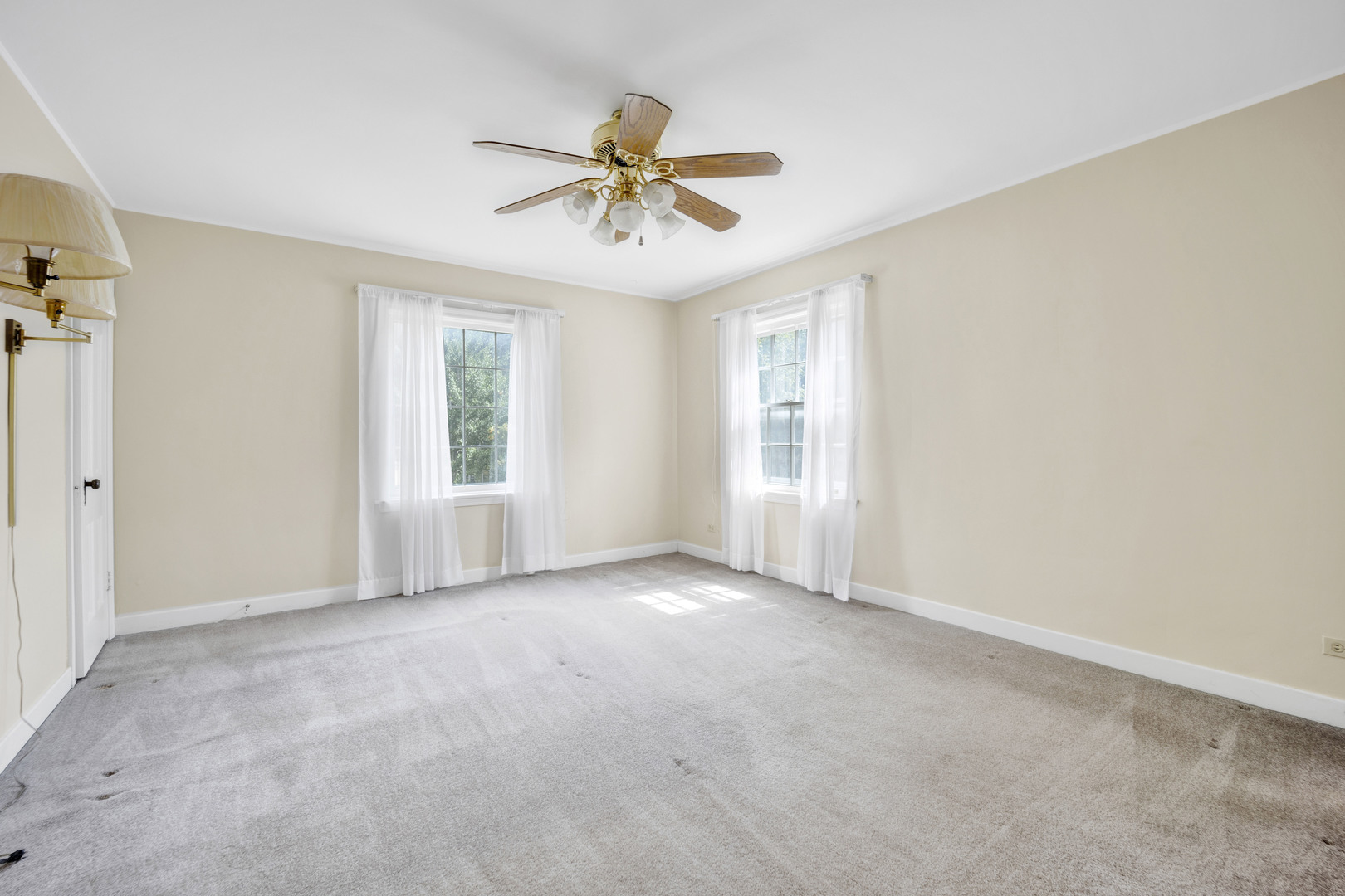 410 Audubon Road Riverside, IL 60546 - Photo 12 of 31 an empty room with windows and fan