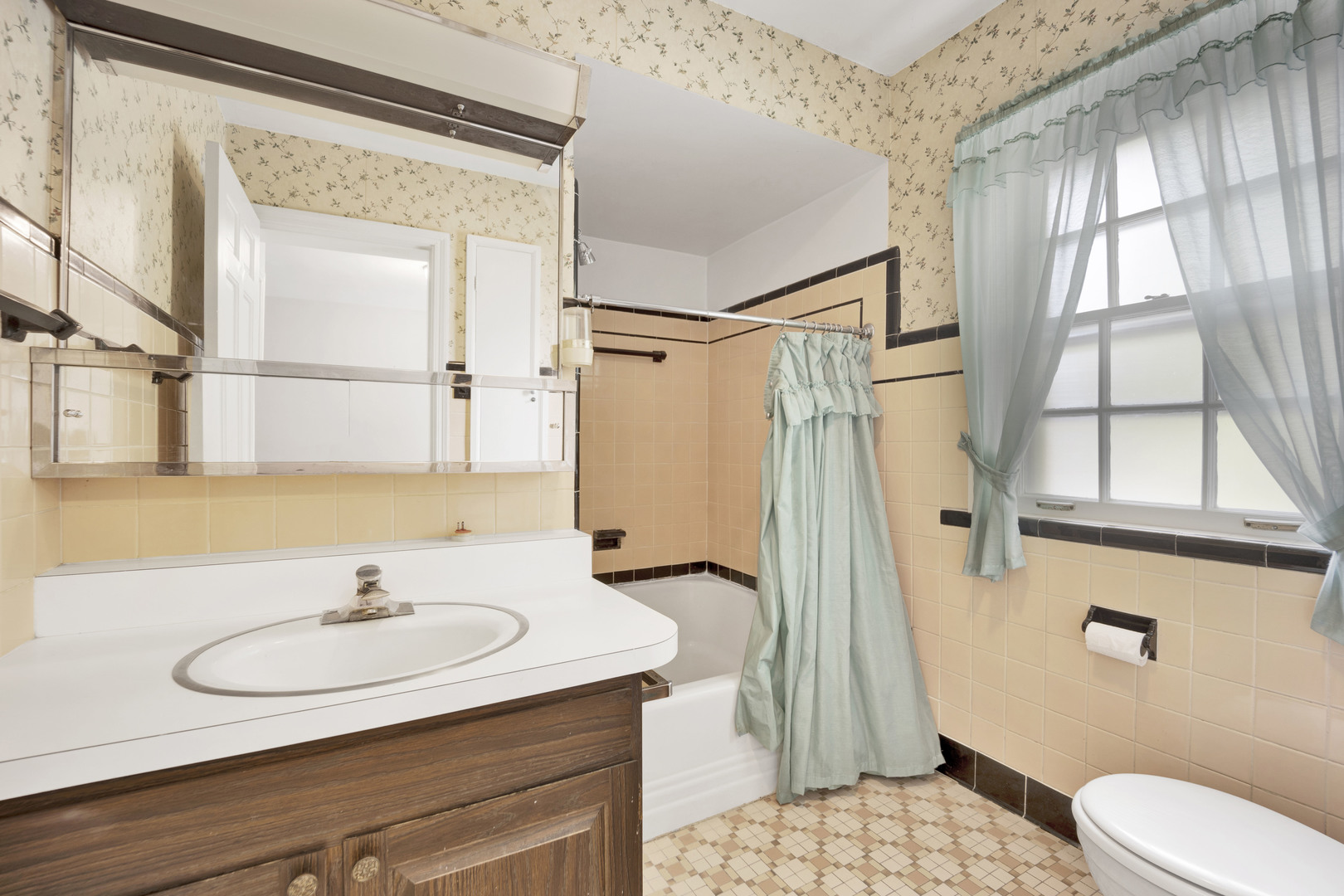410 Audubon Road Riverside, IL 60546 - Photo 13 of 31 a bathroom with a sink a mirror and a shower