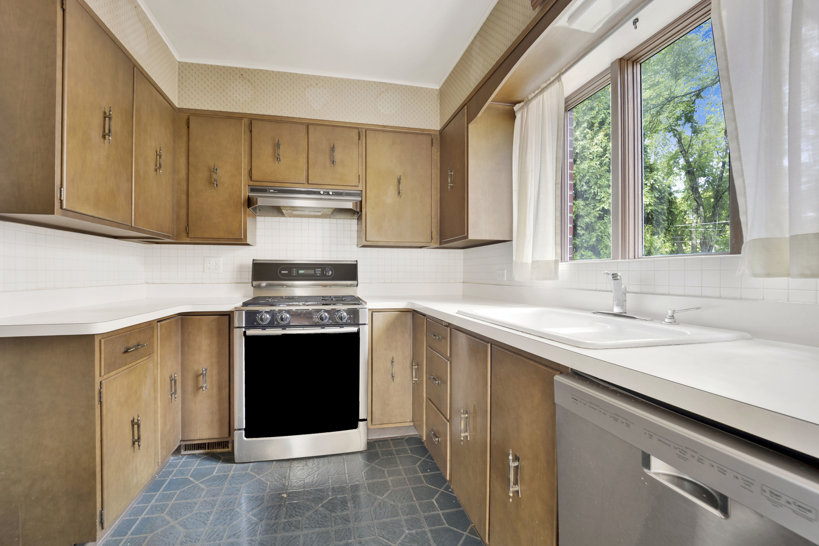 410 Audubon Road Riverside, IL 60546 - Photo 6 of 31 a kitchen with stainless steel appliances granite countertop a stove and a sink