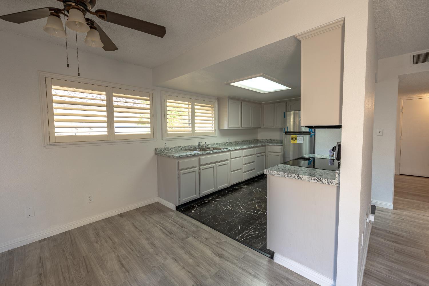 3700 Tully Road, Unit 5 Modesto, CA 95356 - Photo 7 of 38 a kitchen with a stove a sink and a refrigerator