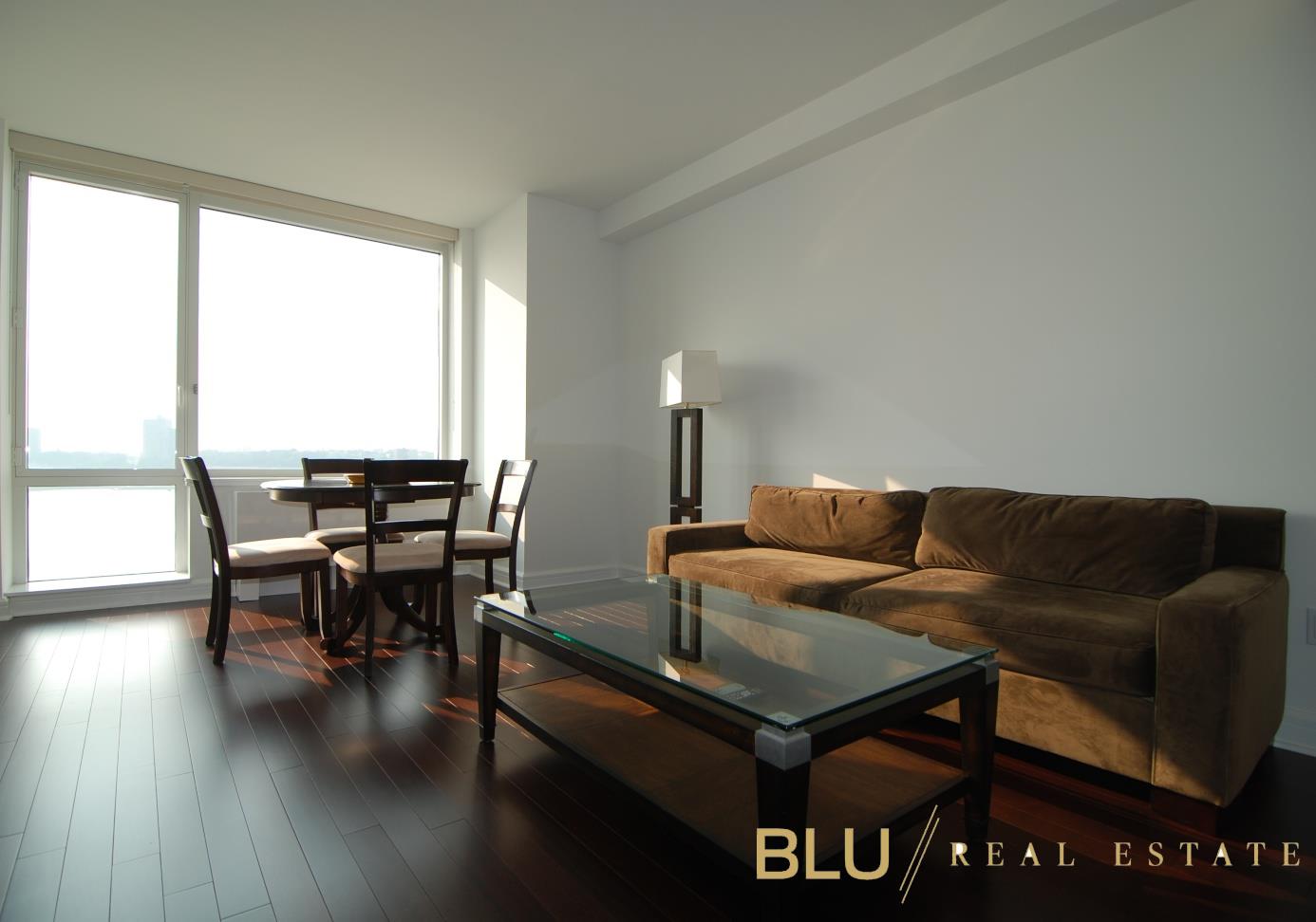100 Riverside Boulevard, Unit 16E Manhattan, NY 10069 - Photo 10 of 11 a living room with furniture and wooden floor