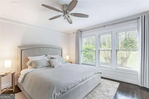 a bedroom with a large bed and a window