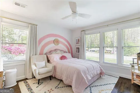 a bedroom with a bed and a couch