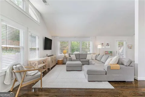 a living room with furniture and a flat screen tv