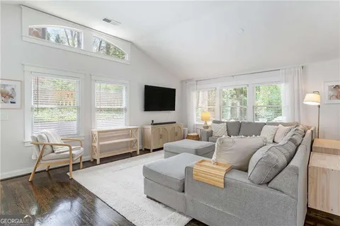 a living room with furniture and a flat screen tv