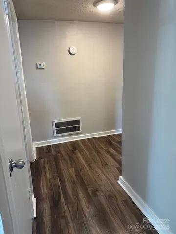 a view of a room with wooden floor