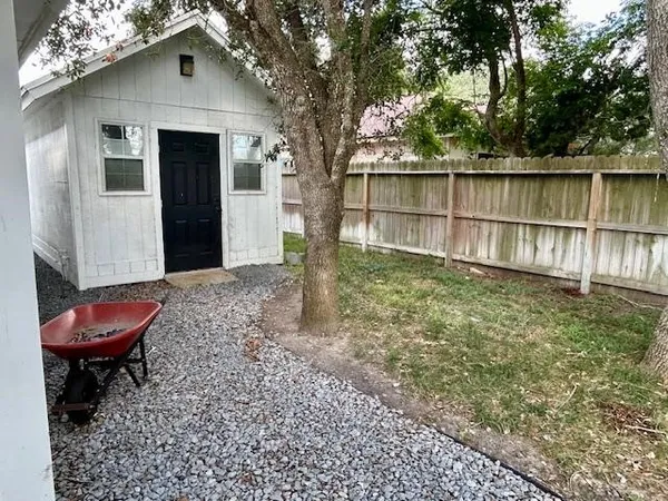 a view of a porch with chairs and backyard