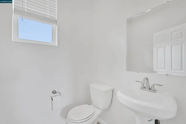 a white toilet sitting next to a bathroom sink