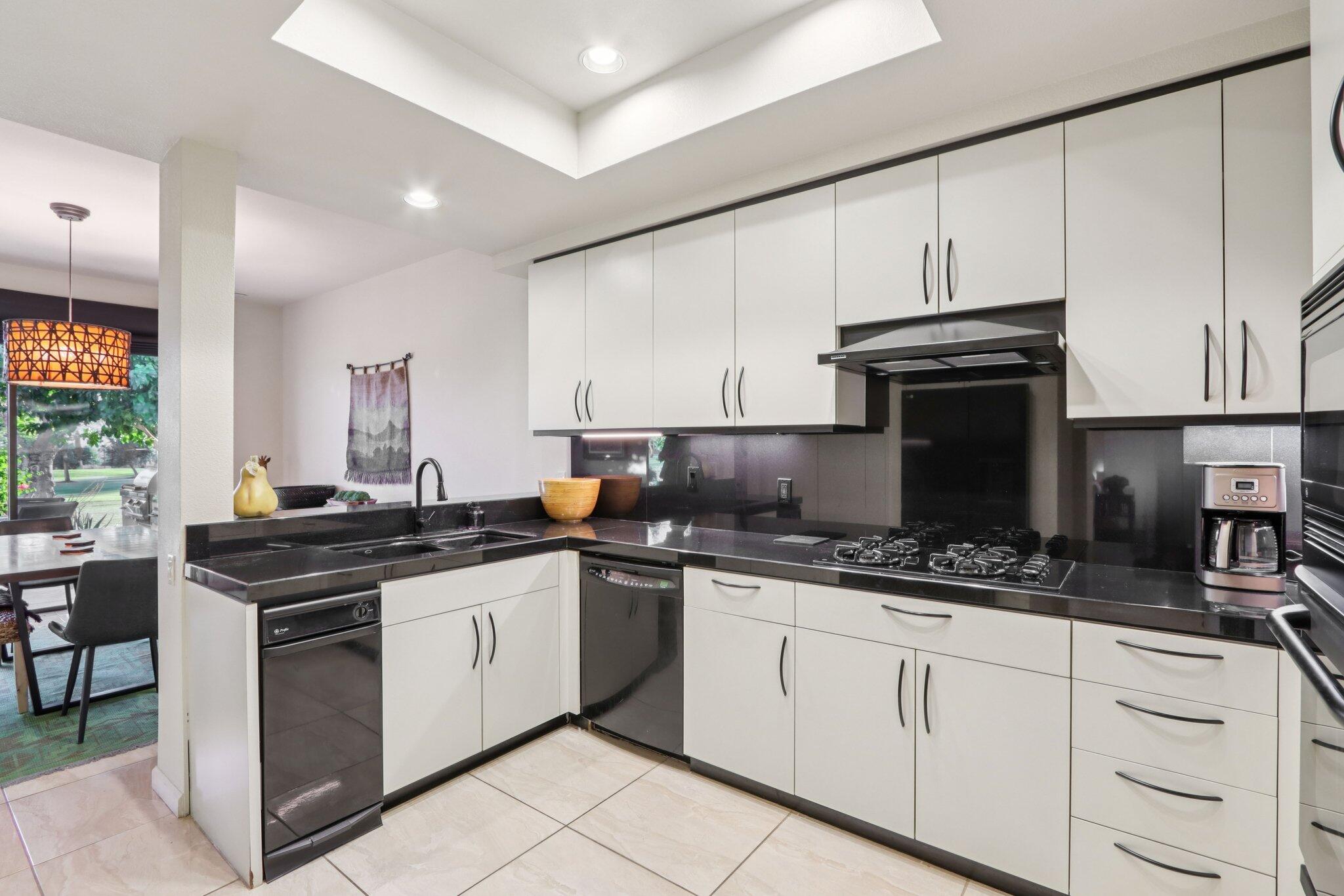 829 Inverness Drive Rancho Mirage, CA 92270 - Photo 12 of 27 a kitchen with stainless steel appliances a stove sink and cabinets