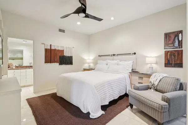 a bedroom with a bed and couch