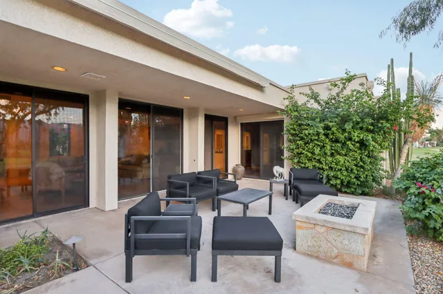 a building outdoor space with patio furniture and potted plants