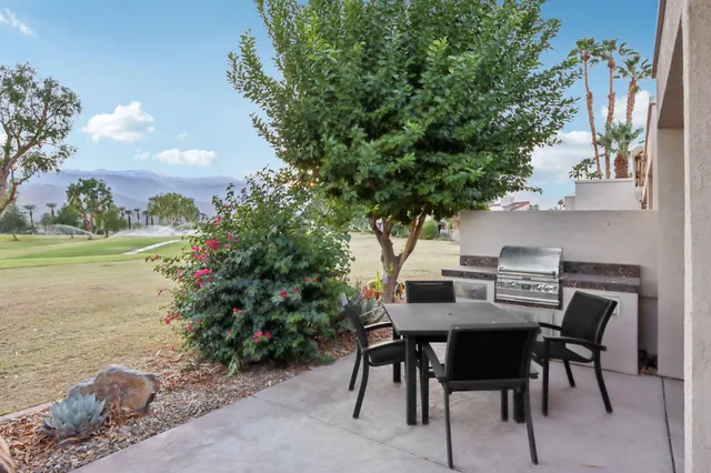 a view of an outside dining space with furniture