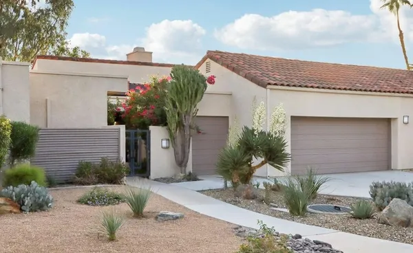 a front view of a house with garden