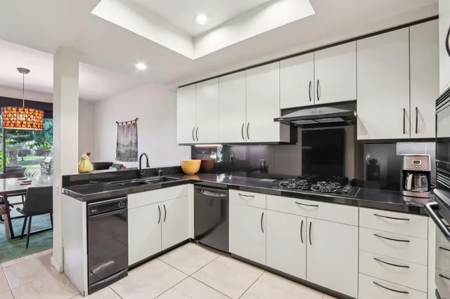 a kitchen with stainless steel appliances a stove sink and cabinets