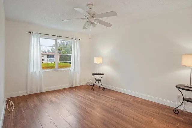 a view of a livingroom with a furniture wooden floor and chandelier