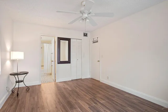 a view of a room with wooden floor and a window