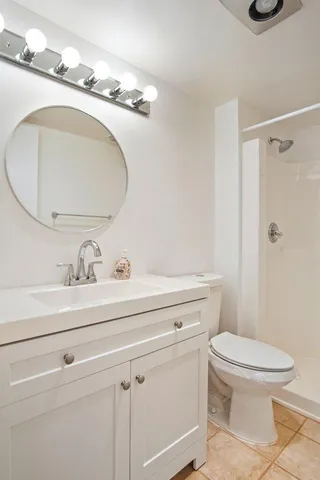 a bathroom with a sink a toilet and a mirror