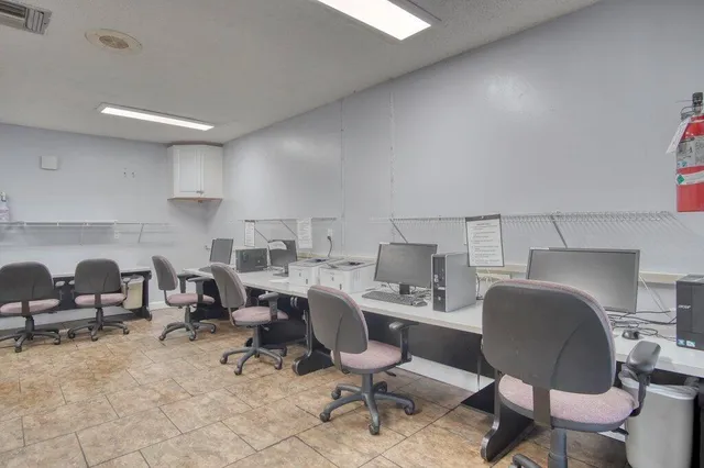 a room with pool table and windows