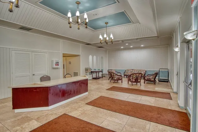 a view of a dining room with furniture and chandelier