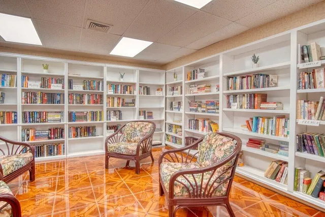 a view of a livingroom with furniture and a bookshelf