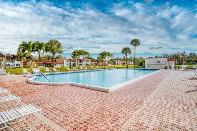 a view of swimming pool with a table and chairs