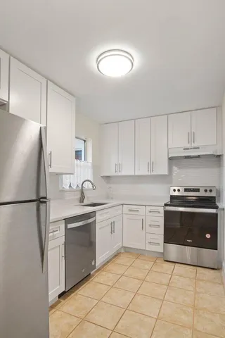 a white refrigerator freezer sitting inside of a kitchen