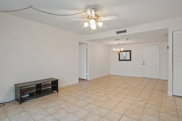 a kitchen with granite countertop a refrigerator stove top oven and sink