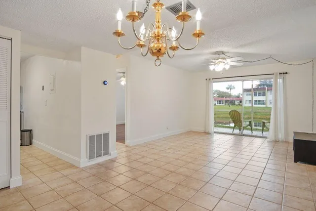 a view of a livingroom with a chandelier fan