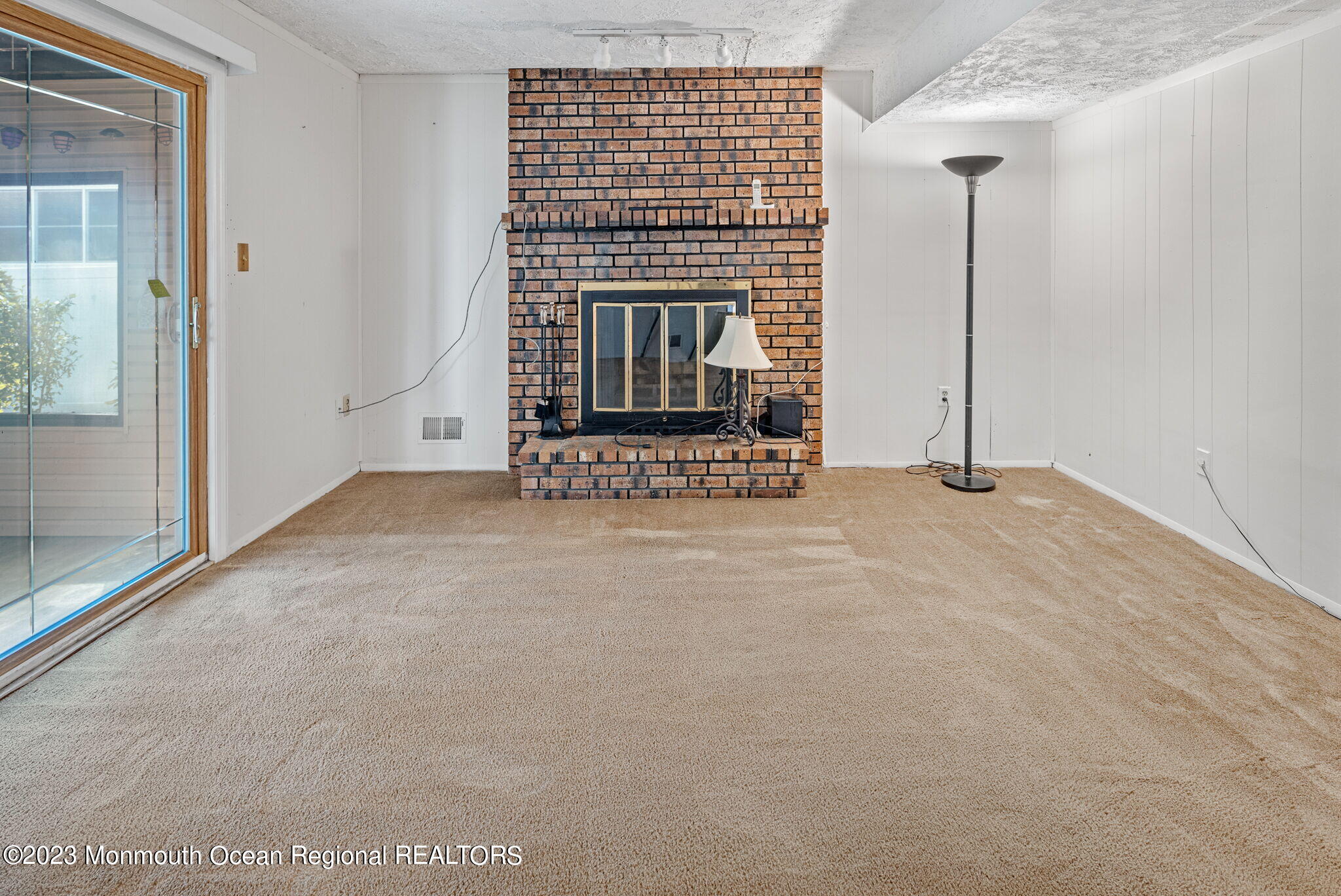 187 Torpedo Road Manahawkin, NJ 08050 - Photo 8 of 10 a view of an empty room with a fireplace