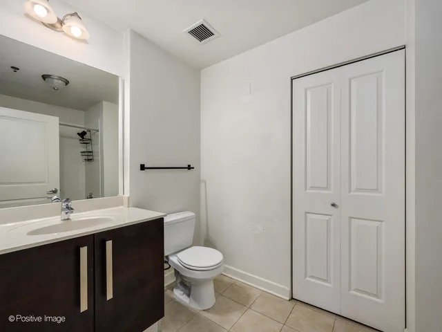 a bathroom with a sink a toilet and mirror