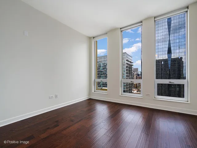 a view of wooden floor and windows in a room