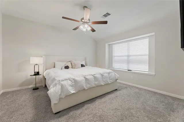 a bedroom with a bed and window