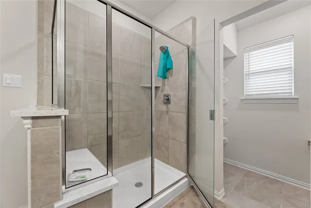 a bathroom with a shower and a mirror