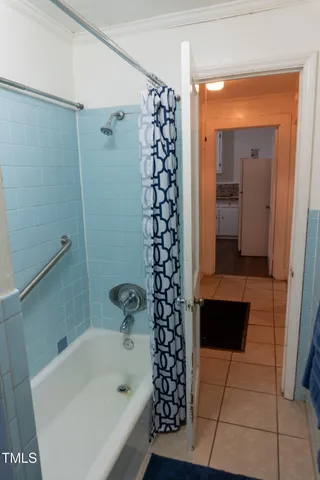 a bathroom with a bathtub and shower