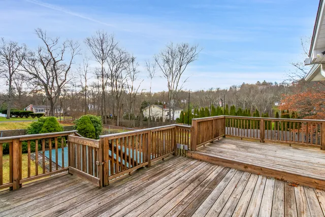 a view of balcony with wooden floor and fence