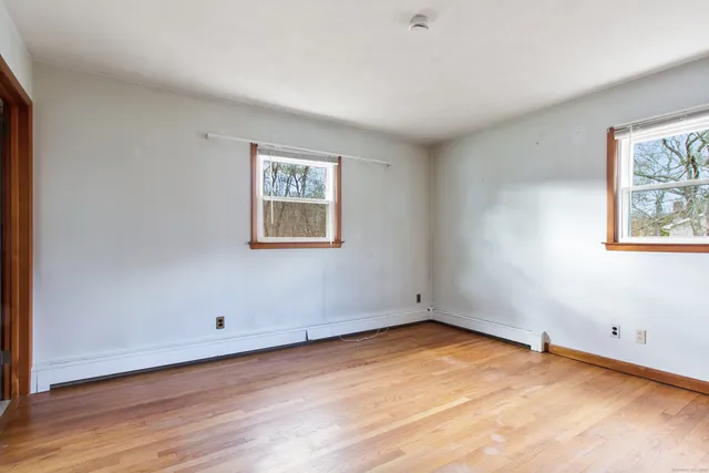 a view of a room with wooden floor and window
