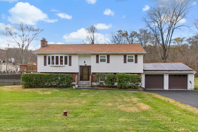 a front view of a house with a yard