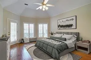 a spacious bedroom with a bed couch and a large window